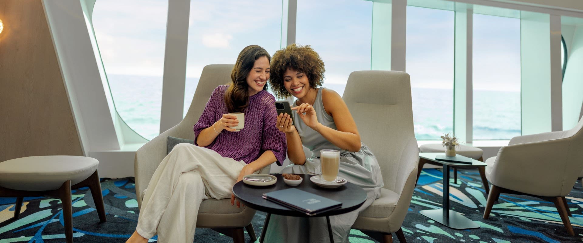 Mein Schiff Relax 2 women look at mobile phone