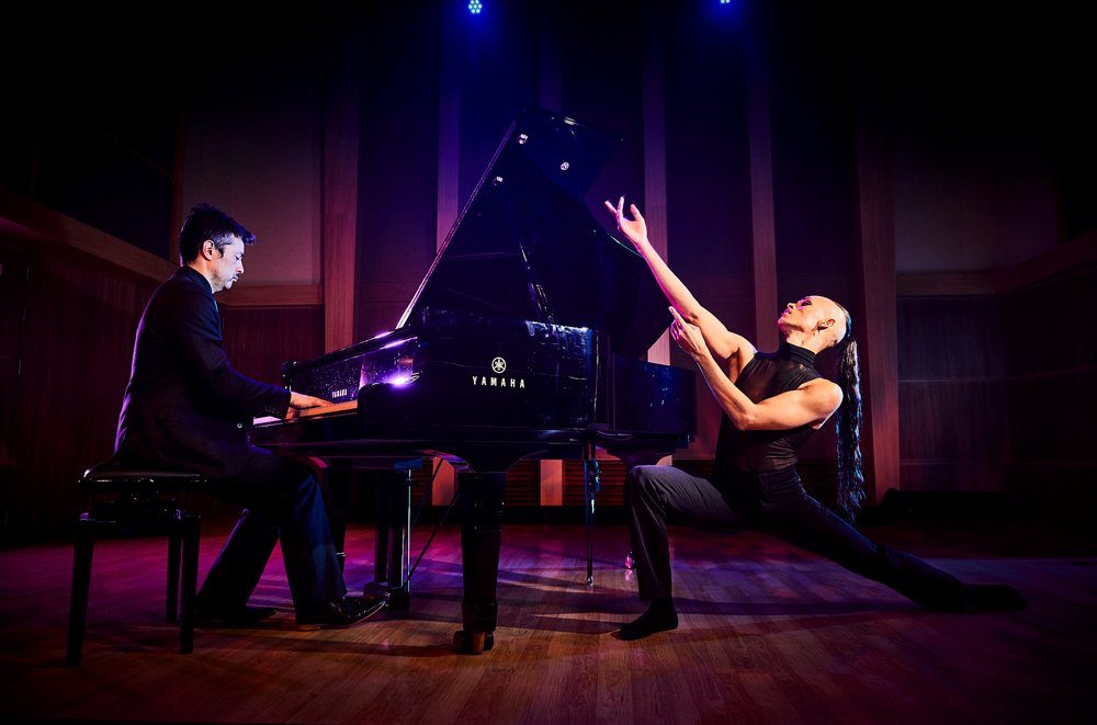 Ein Pianist und Tänzer stehen zusammen auf der Bühne.