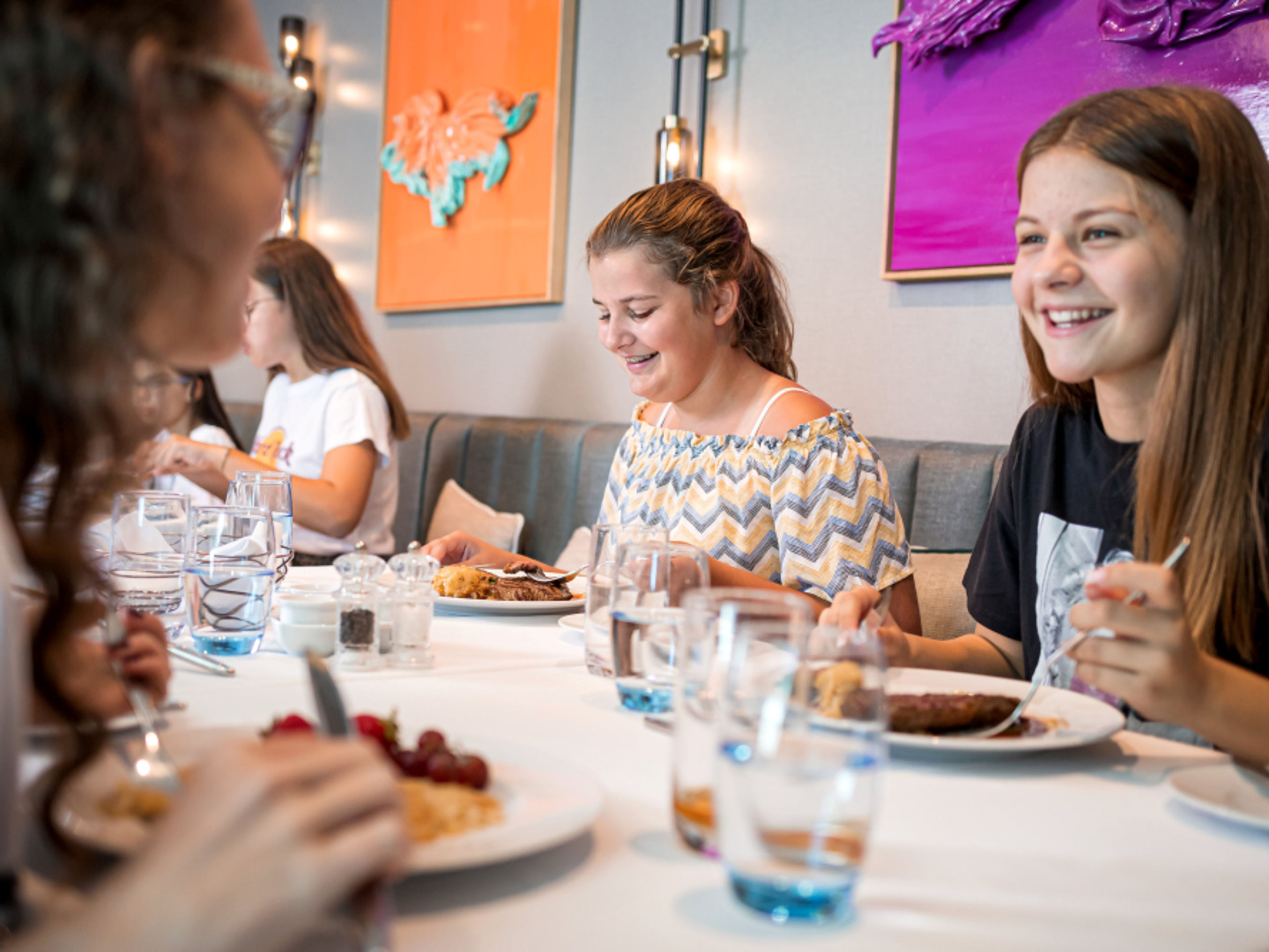 Girls are laughing and eating together in a restaurant. Girls are laughing and eating together in a restaurant.