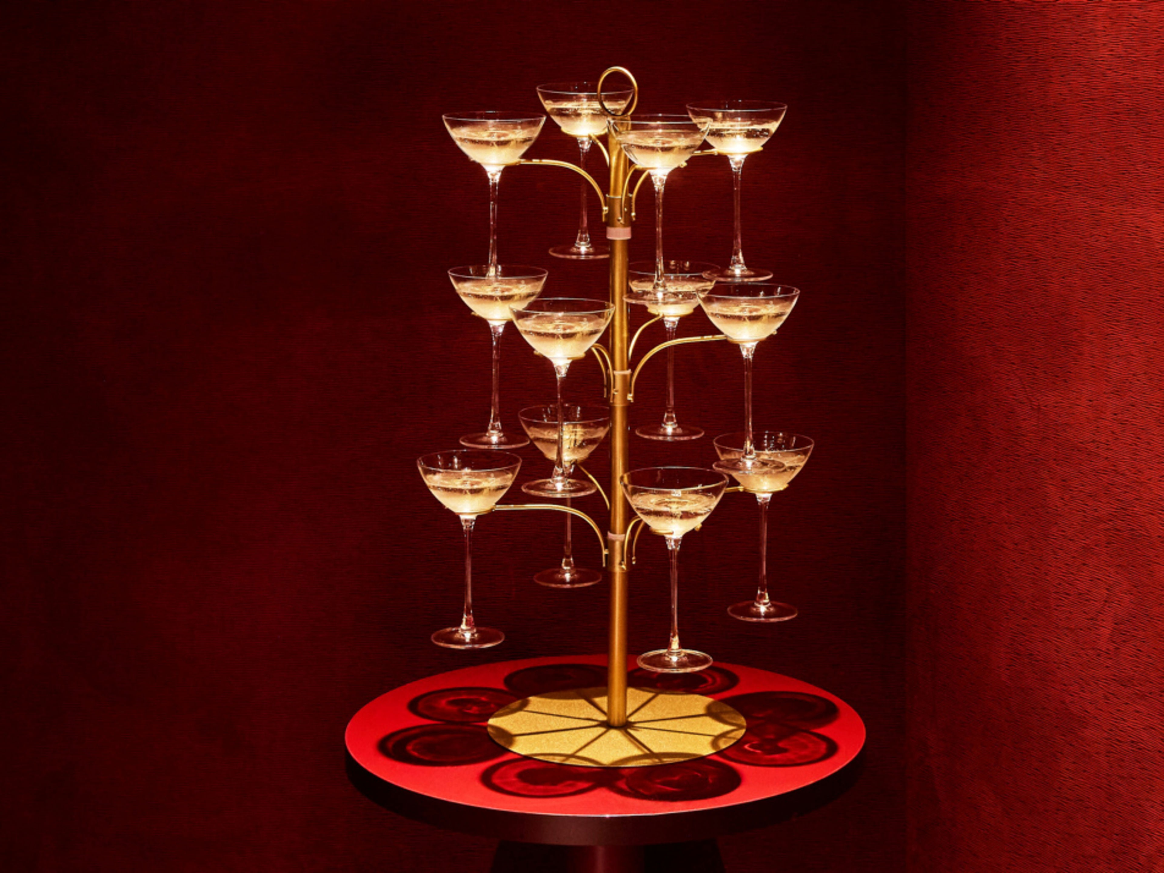 Champagne pyramid in front of red armchairs and sofa in an elegant room. Champagne pyramid in front of red armchairs and sofa in an elegant room.