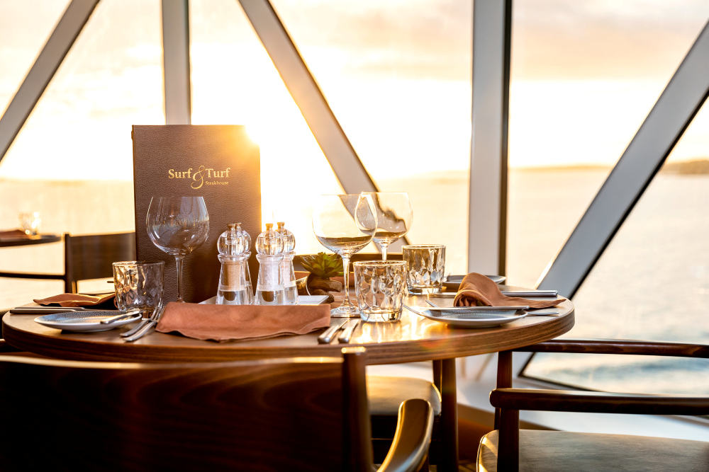 A table set at the Surf & Turf Steakhouse at sunset.