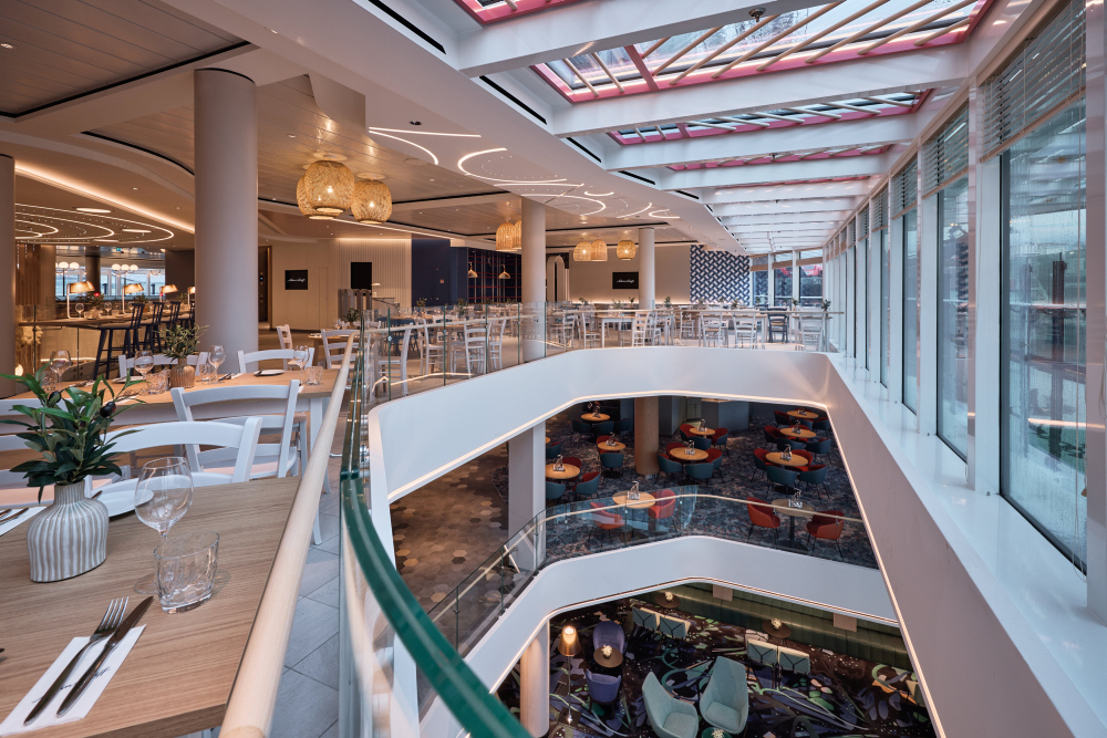 Restaurants on a cruise ship in the Mein Schiff fleet, featuring a modern design and glass balustrades.