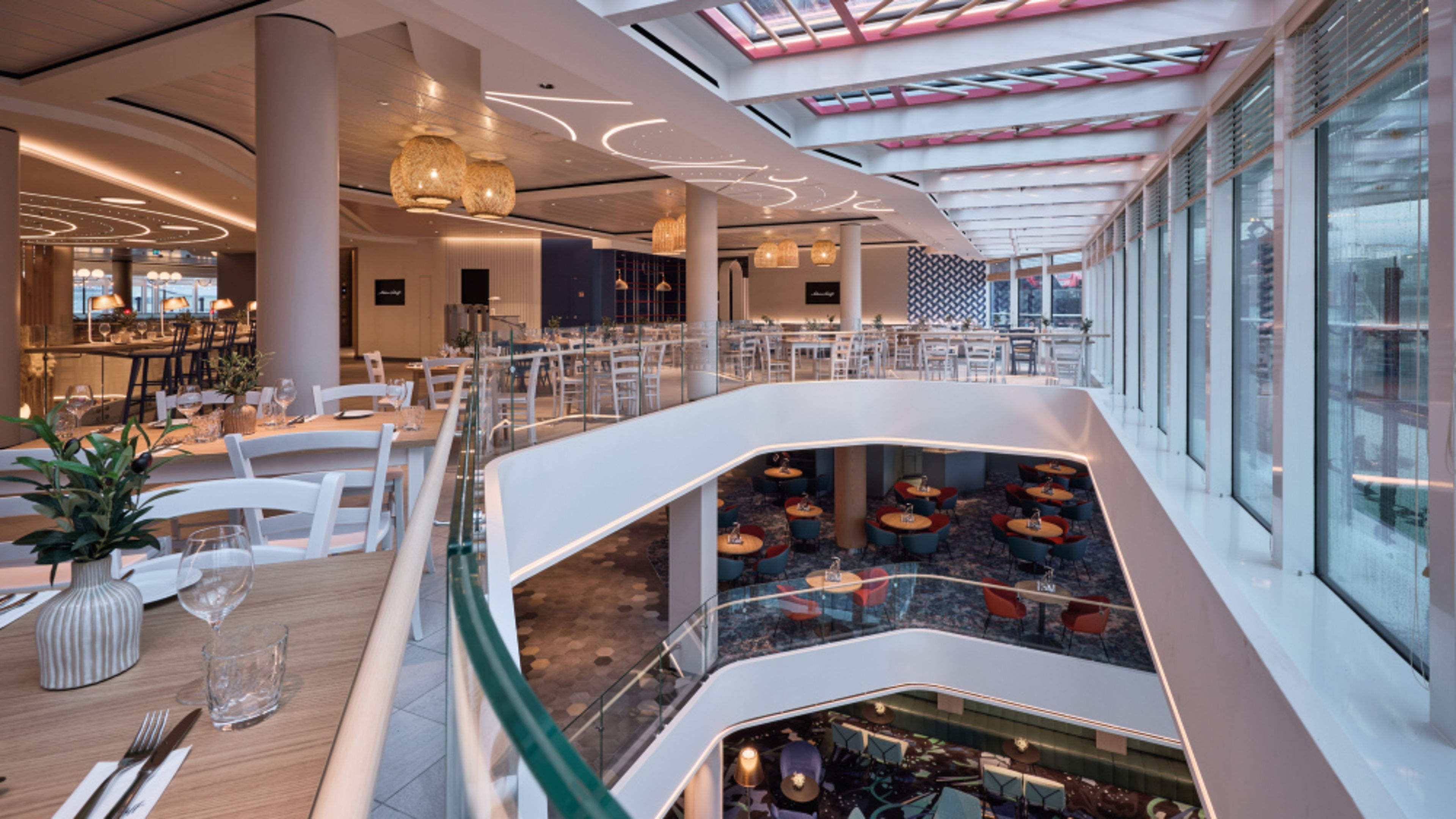 Restaurants on a cruise ship in the Mein Schiff fleet, featuring a modern design and glass balustrades. Restaurants on a cruise ship in the Mein Schiff fleet, featuring a modern design and glass balustrades.