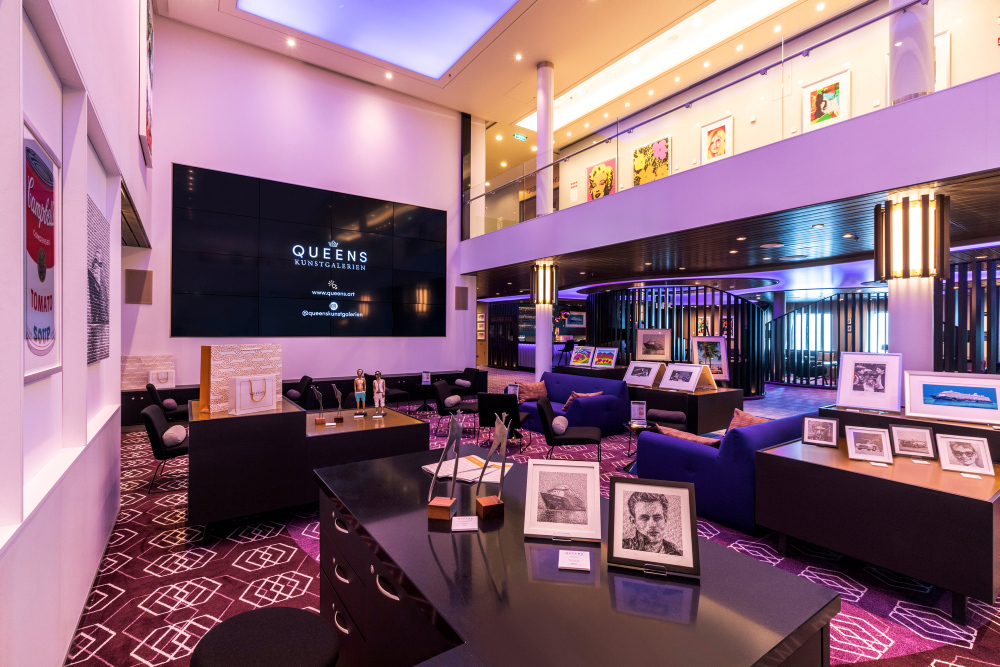 Queens Art Gallery Lounge, featuring artworks, purple lighting and seating areas in a modern interior