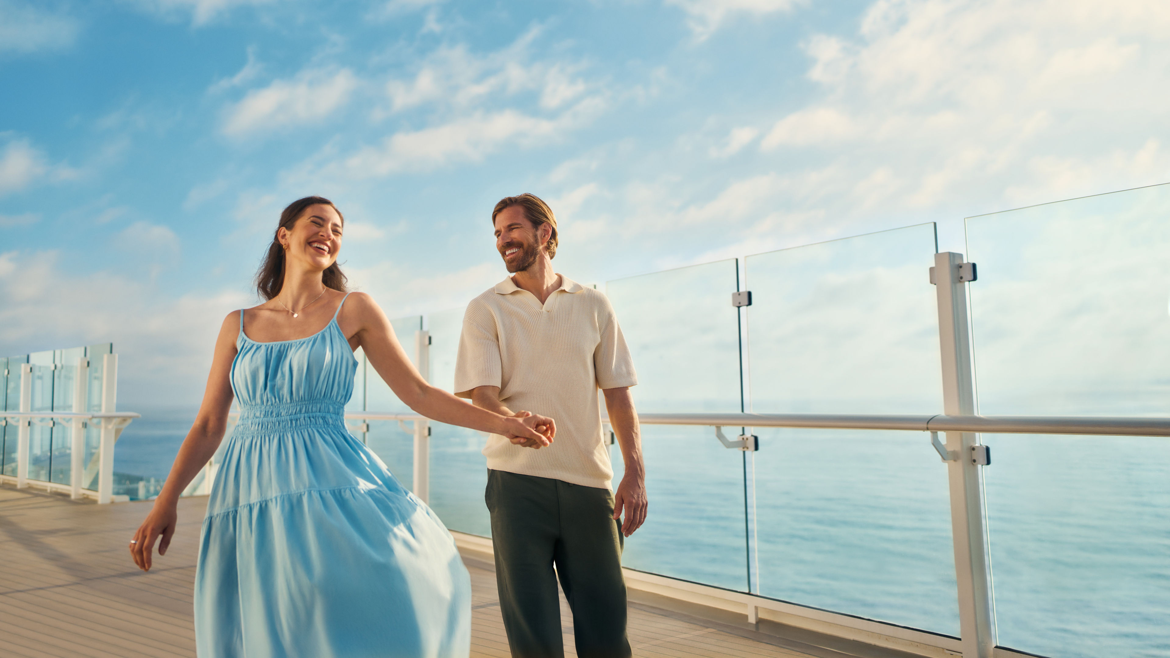Couple walking on cruise ship of the Mein Schiff® fleet, blue sky.
