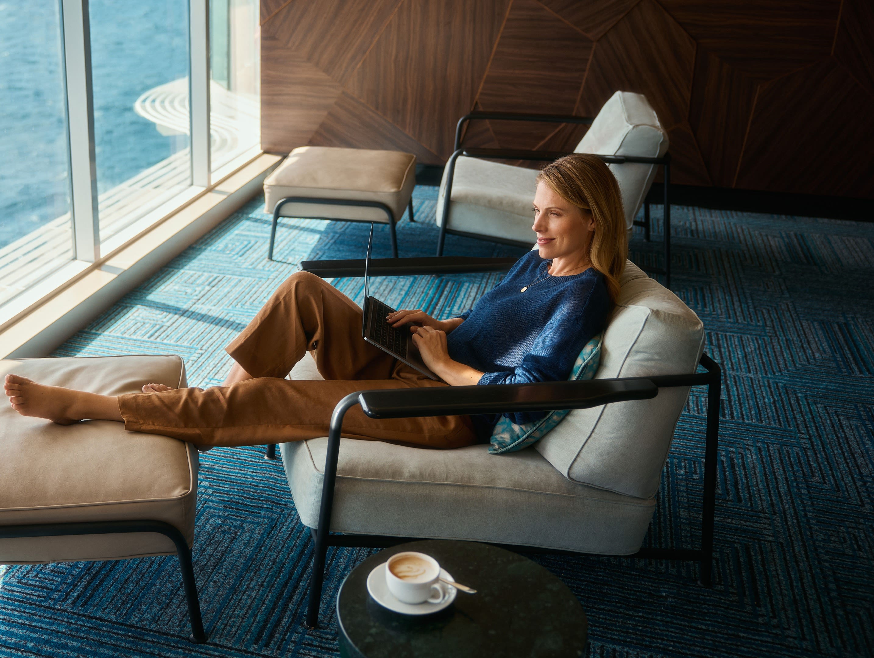 Frau entspannt mit Laptop auf Kreuzfahrtschiff, Meerblick. Frau entspannt mit Laptop auf Kreuzfahrtschiff, Meerblick.