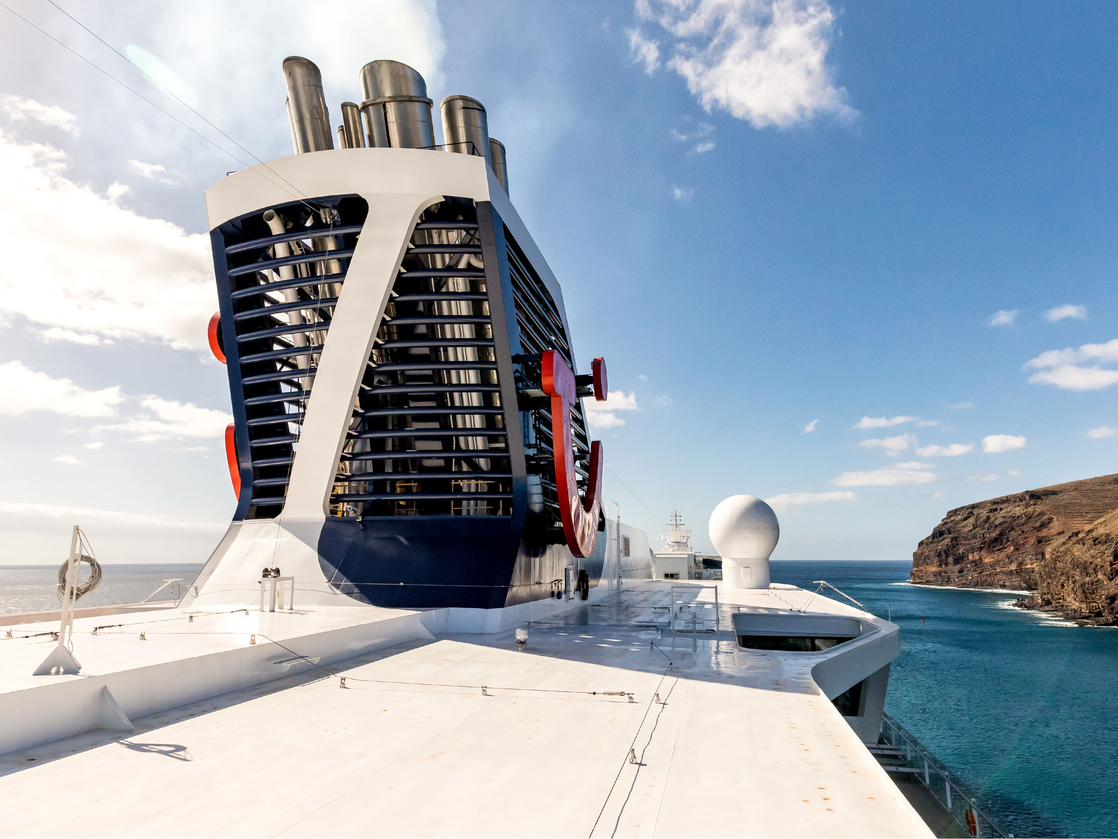 Kreuzfahrtschiff der Mein Schiff® Flotte vor felsiger Küste, blauer Himmel. Kreuzfahrtschiff der Mein Schiff® Flotte vor felsiger Küste, blauer Himmel.