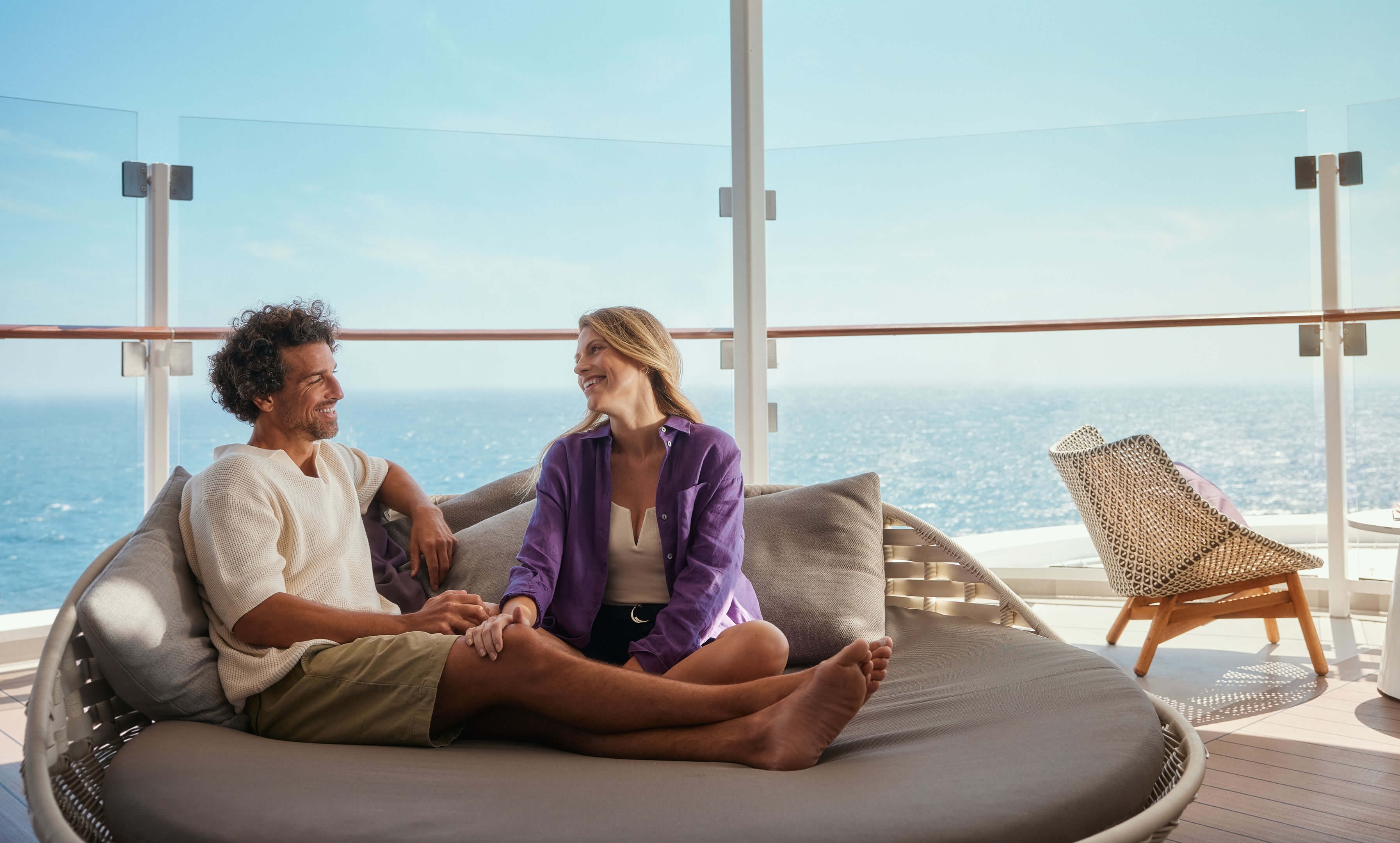 Couple relaxing on cruise ship of the Mein Schiff® fleet, sea view.