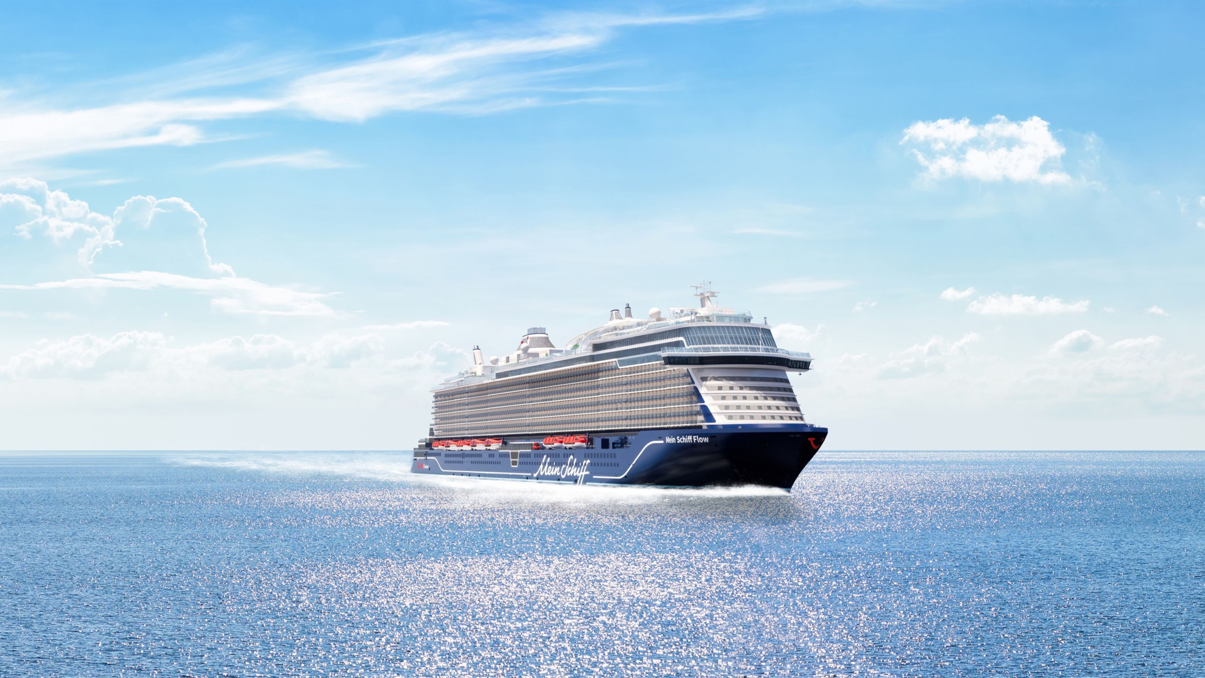 Kreuzfahrtschiff der Mein Schiff® Flotte auf offenem Meer unter blauem Himmel. Kreuzfahrtschiff der Mein Schiff® Flotte auf offenem Meer unter blauem Himmel.